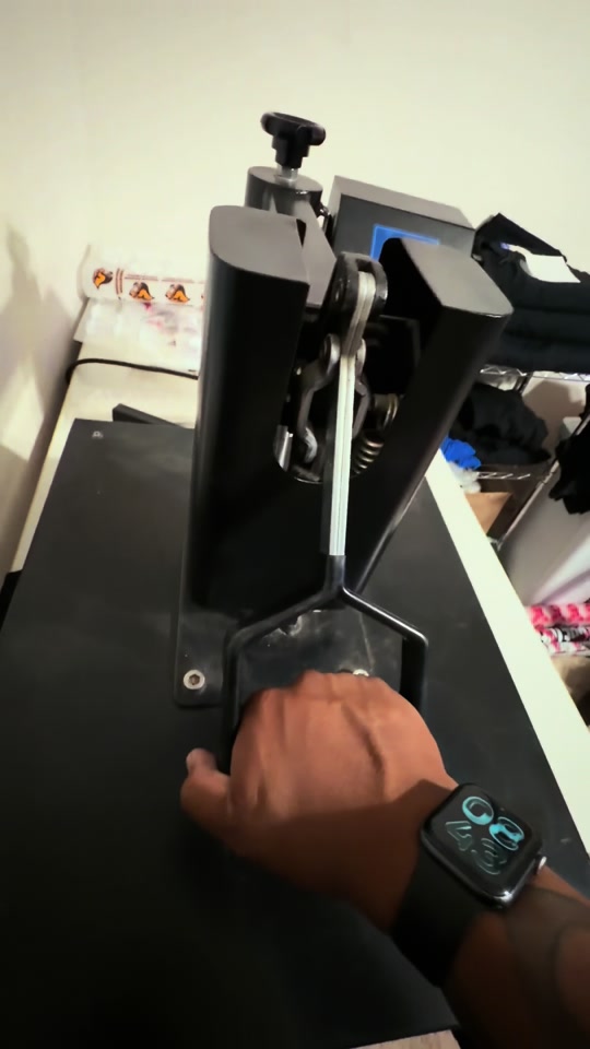 A still from Derick’s FIGHT TOGETHER campaign video showing a shirt-printing press