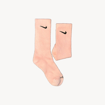 Pink crew sock beside a folded sock
